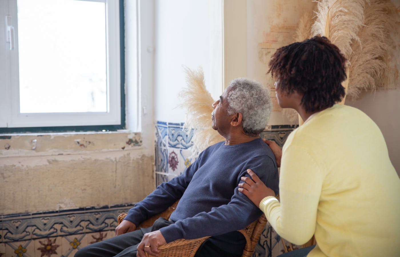 An adult caring for an aging parent, protected by life insurance